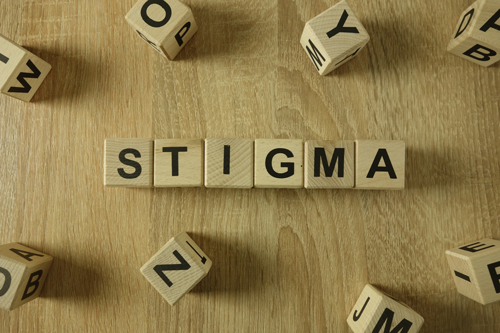 a photo of a blocks scattered spelling the word 'Stigma'